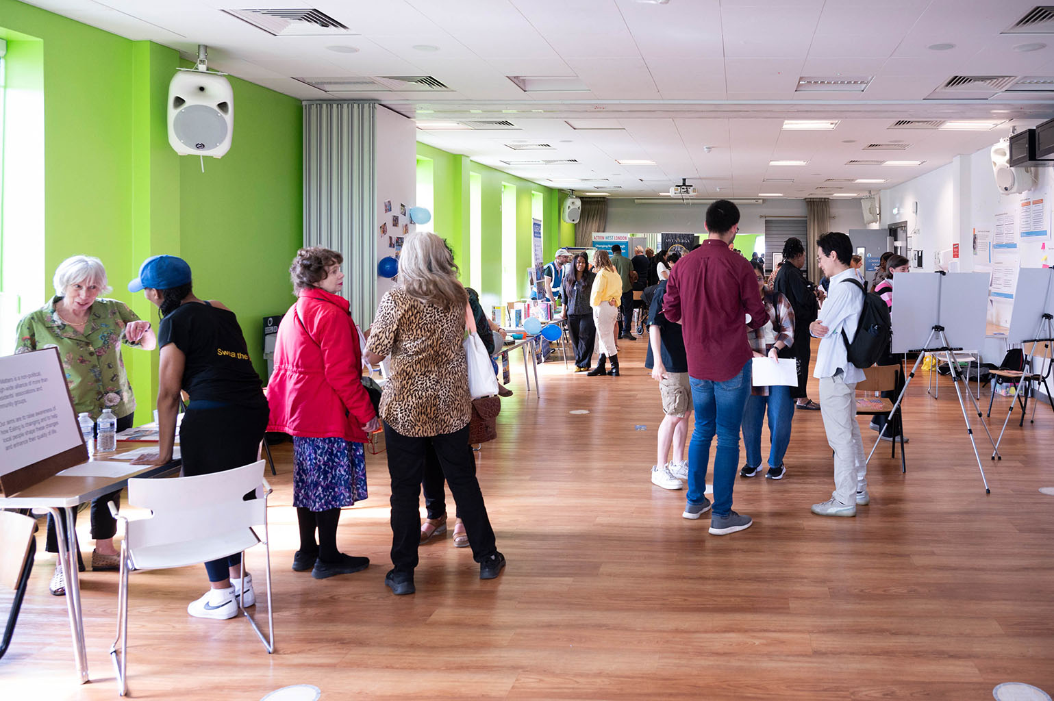 A large group of people talking in a hall