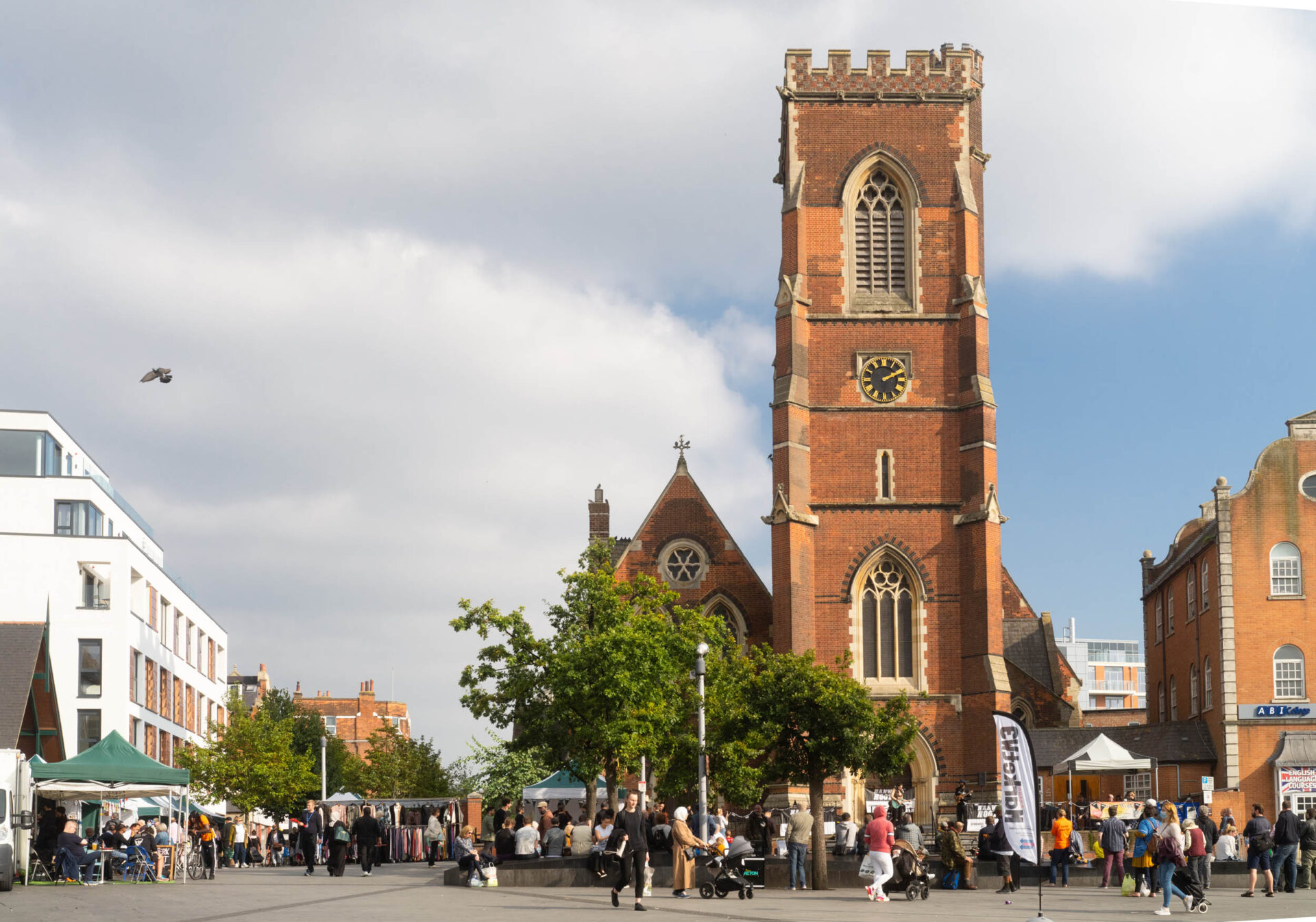 The main square in Acton, St Mary's Church and people milling around.