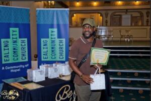A man holding a certificate and bag