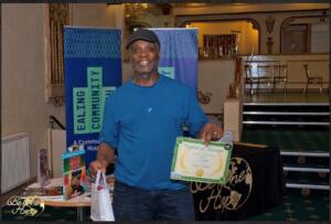 A man holding a certificate and bag